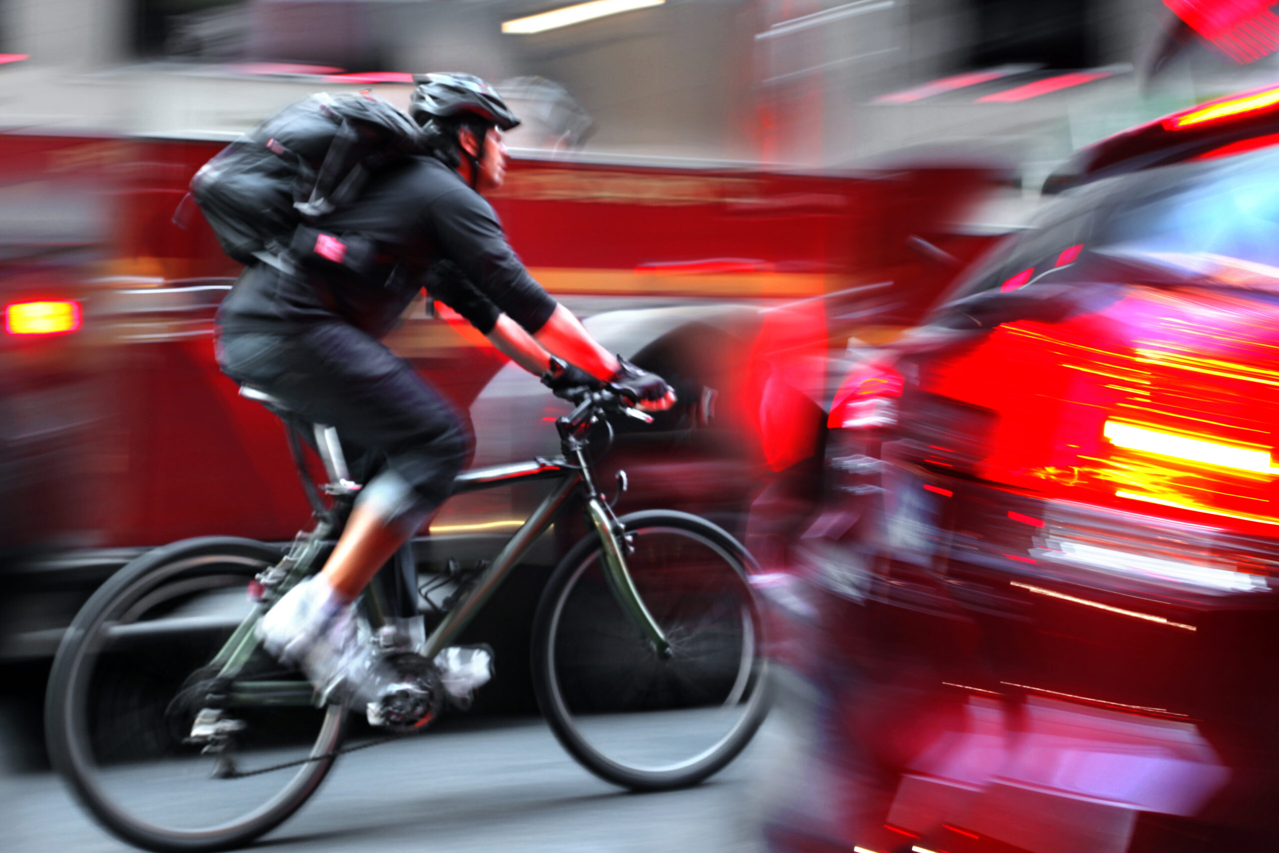 Cyclist,In,Traffic,On,The,City,Roadway,Motion,Blur