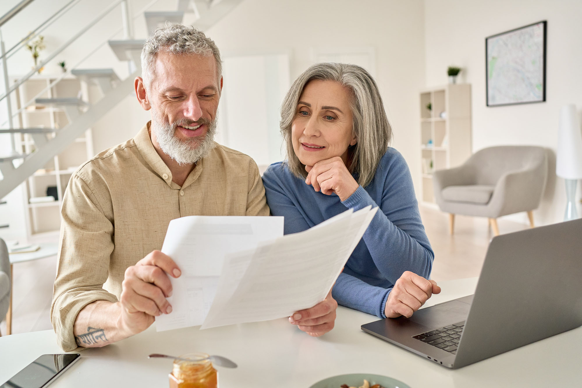 Middle,Aged,Senior,Old,Couple,Holding,Documents,Reading,Paper,Bills senior couple looking at bills