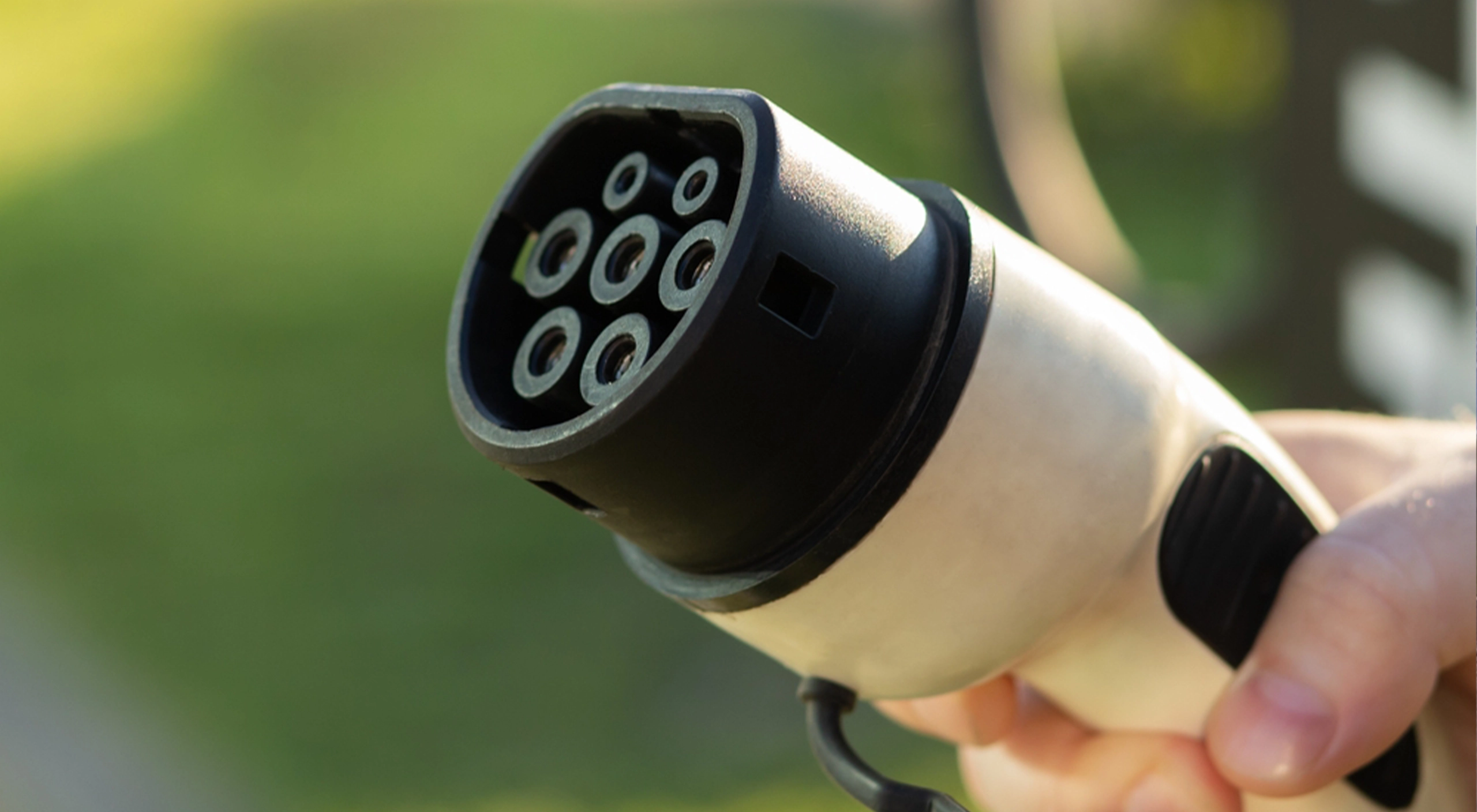 Person charging ev charger demonstrating EV charger strength