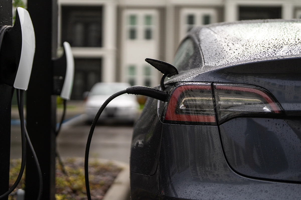 electric car charging using public ev charger in a car park