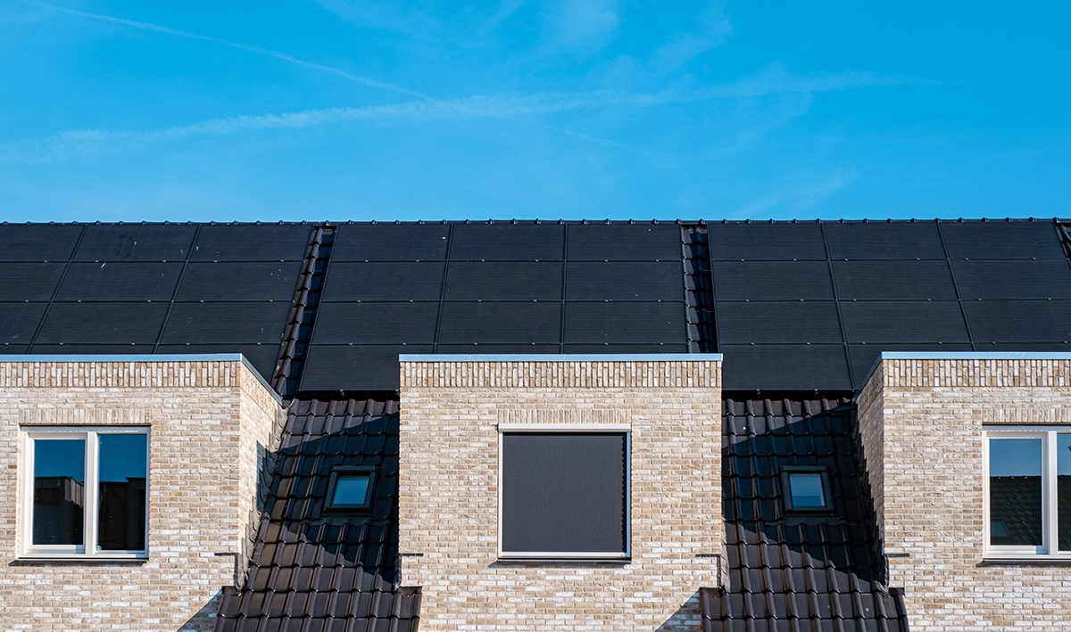 solar-panels-hospitality Solar panels for a hospitality business installed on a hotel roof on a clear sunny day.