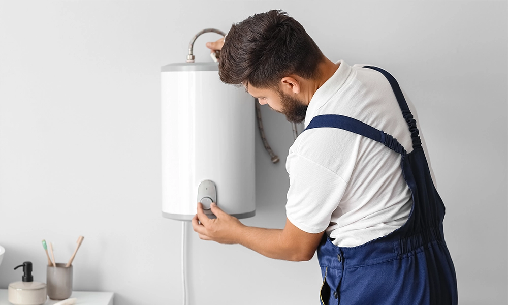 Electric Boilers Guide Plumber adjusting electric boiler