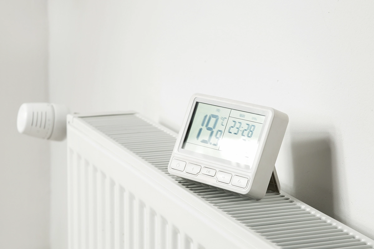 Heat pump efficiency A radiator with a smart thermostat on top of it